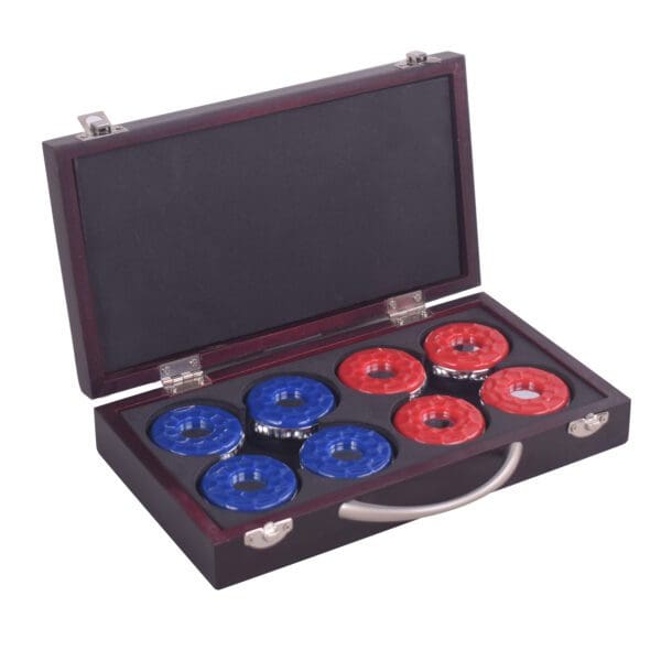 A set of Shuffleboard Pucks with Case - Set of 8 in a wooden case.