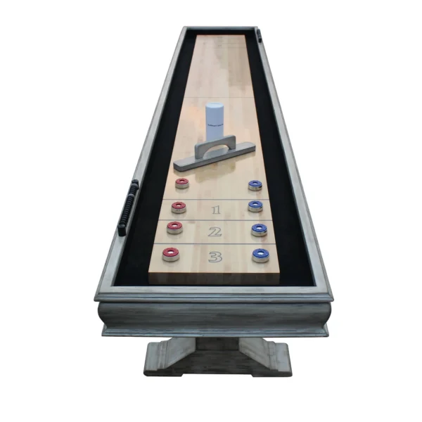 A Montecito 12-ft Shuffleboard Table - Driftwood Finish with a board and a set of dice.