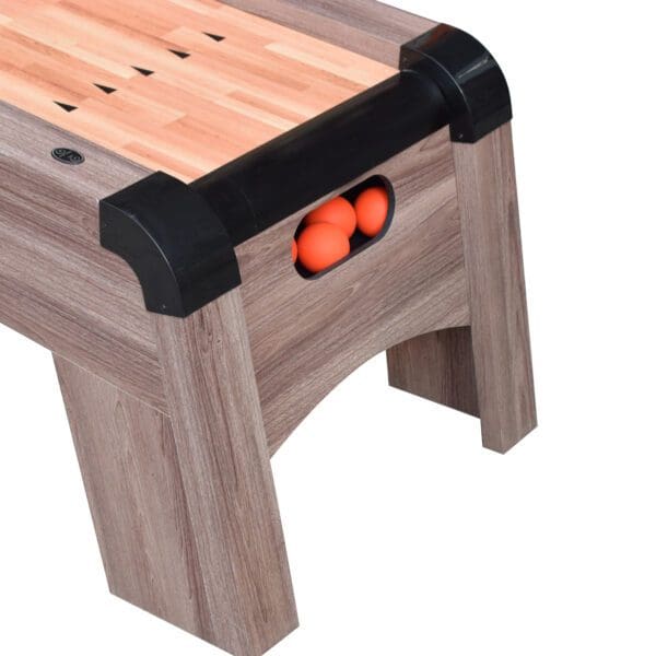 A Shooting Star 9-ft Roll Hop and Score Arcade Game Table with LED Scoring with orange balls.