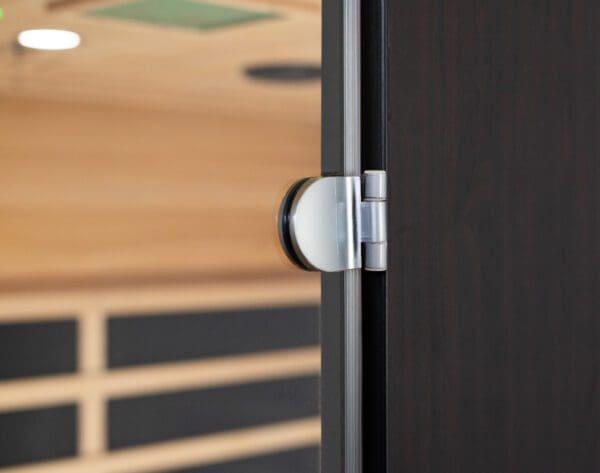 A close up of a door with a Sirona 3-Person Hemlock Infrared Sauna with 8 Carbon Heaters handle.