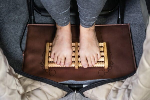 A woman's feet resting on a Valerian Portable Sauna.