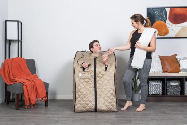 A woman is standing next to a man in a Valerian Portable Sauna.