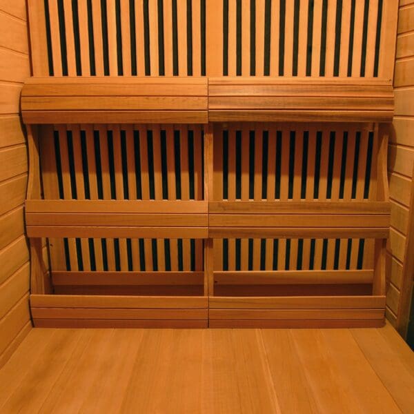 A soothing Whistler 4-Person Cedar Corner Infrared Sauna with wooden shelves.