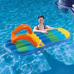 Smiling woman on colorful inflatable pool raft